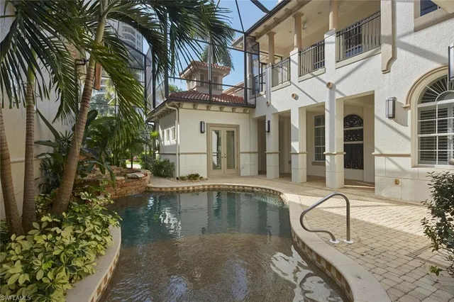 a swimming pool with outdoor seating and yard
