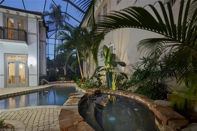 a swimming pool with outdoor seating and yard