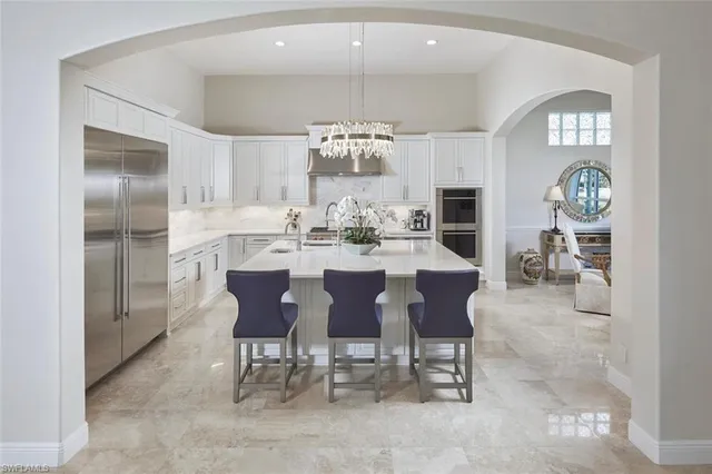 a view of a dining room with furniture and a chandelier