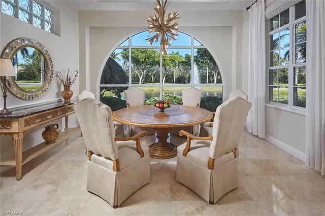 a dining room with furniture a chandelier and a rug