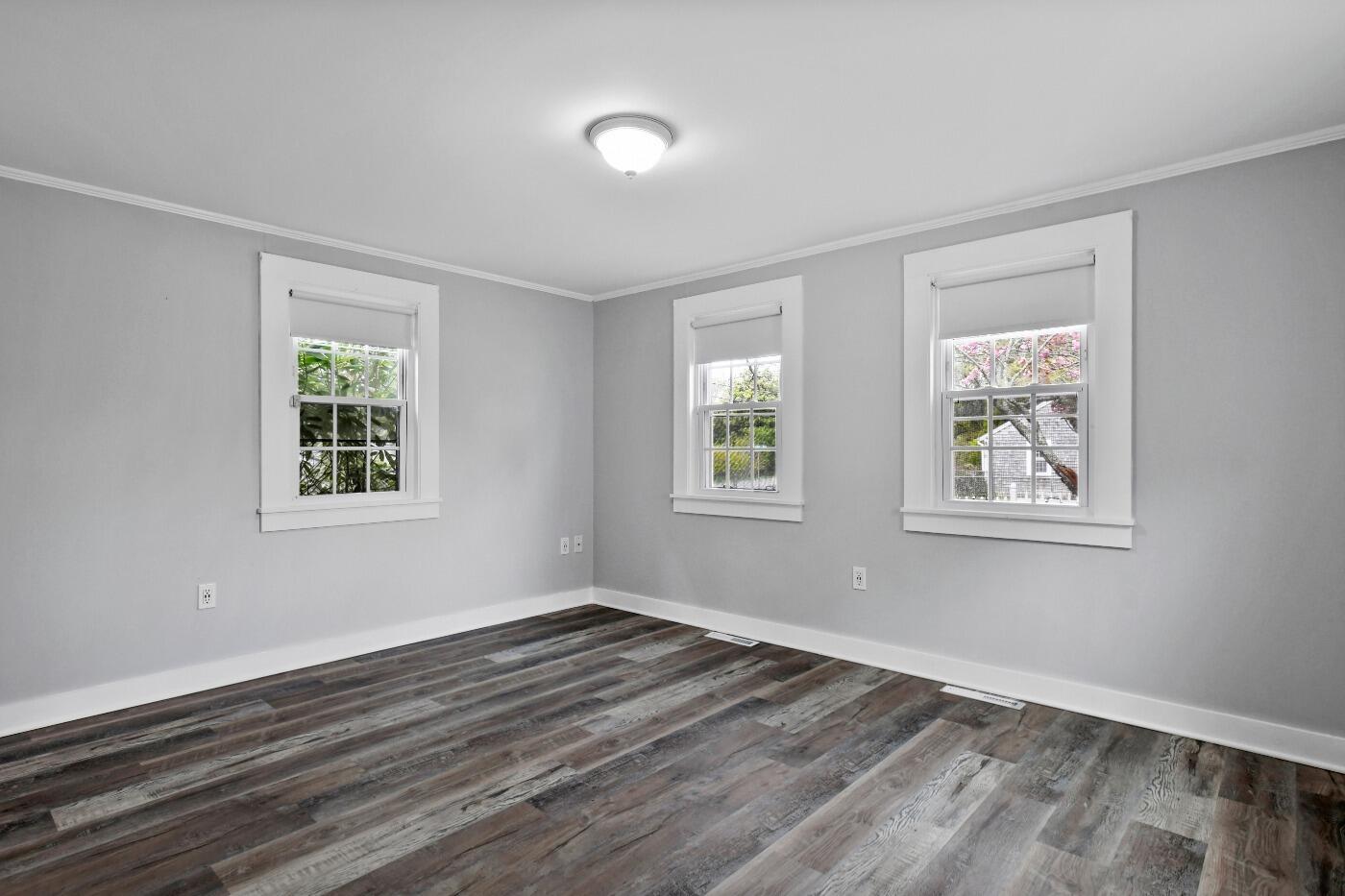 1 Gilbert Road Dennis Port, MA 02639 - Photo 14 of 27 a view of an empty room with wooden floor and a window