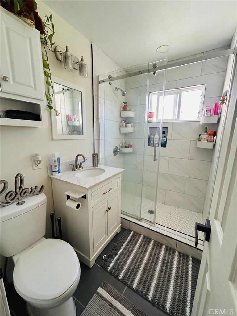 250 Stephens Avenue Riverside, CA 92501 - Photo 12 of 16 a bathroom with a sink mirror toilet and shower