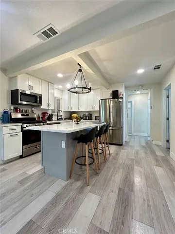 a kitchen with a sink appliances and cabinets