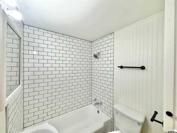 a bathroom with a sink a toilet and bathtub