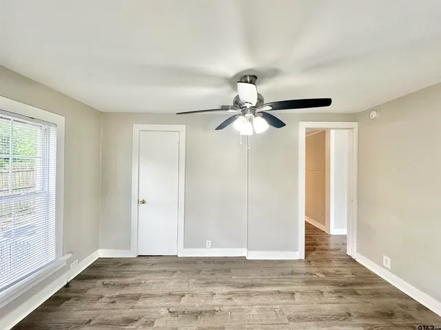a view of a room with wooden floor