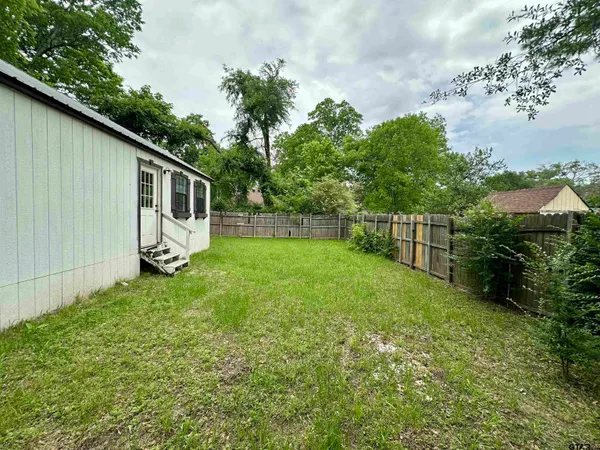a backyard of a house with lots of green space