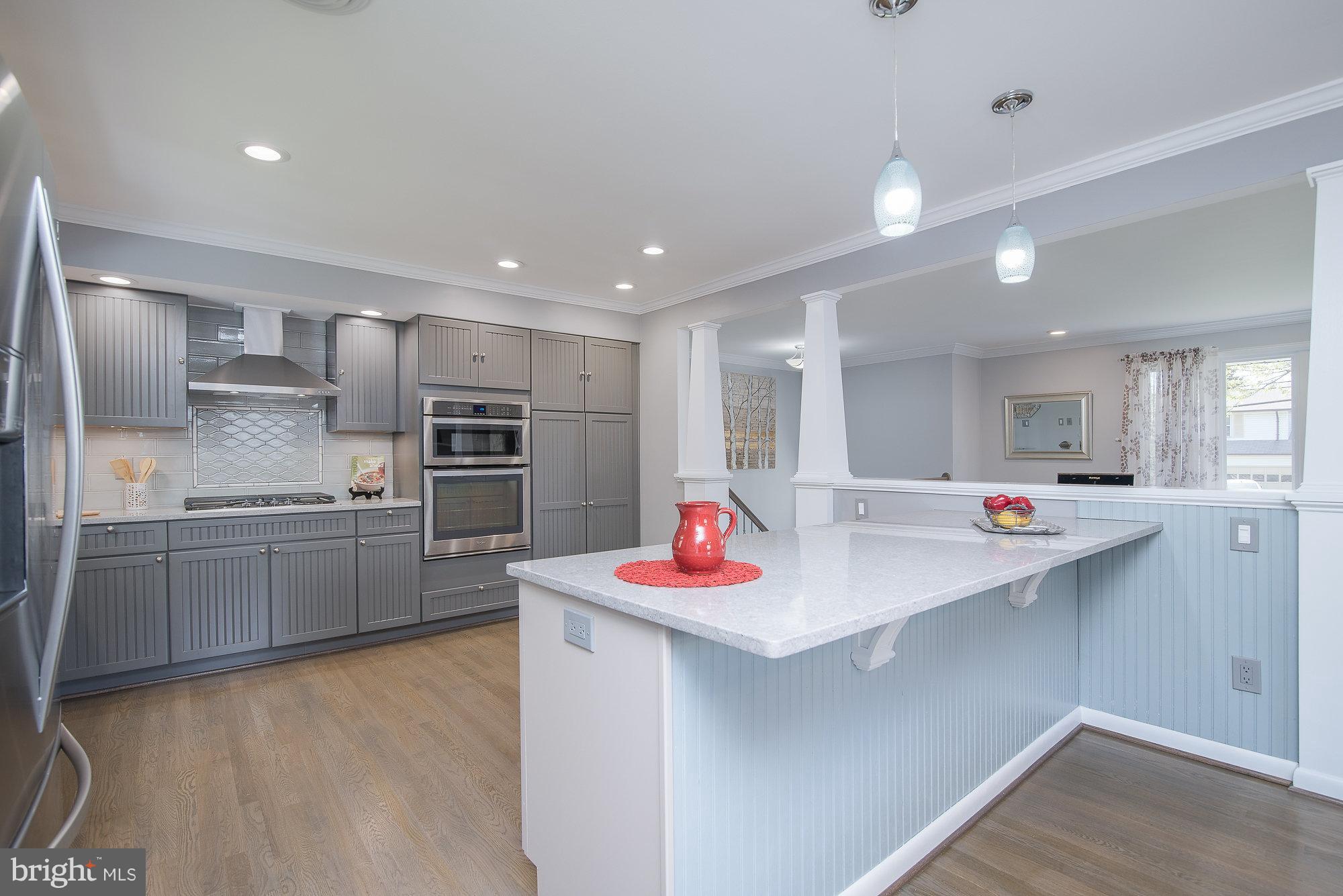 8821 Weems Road Manassas, VA 20110 - Photo 12 of 30 a kitchen with a sink stainless steel appliances and white cabinets