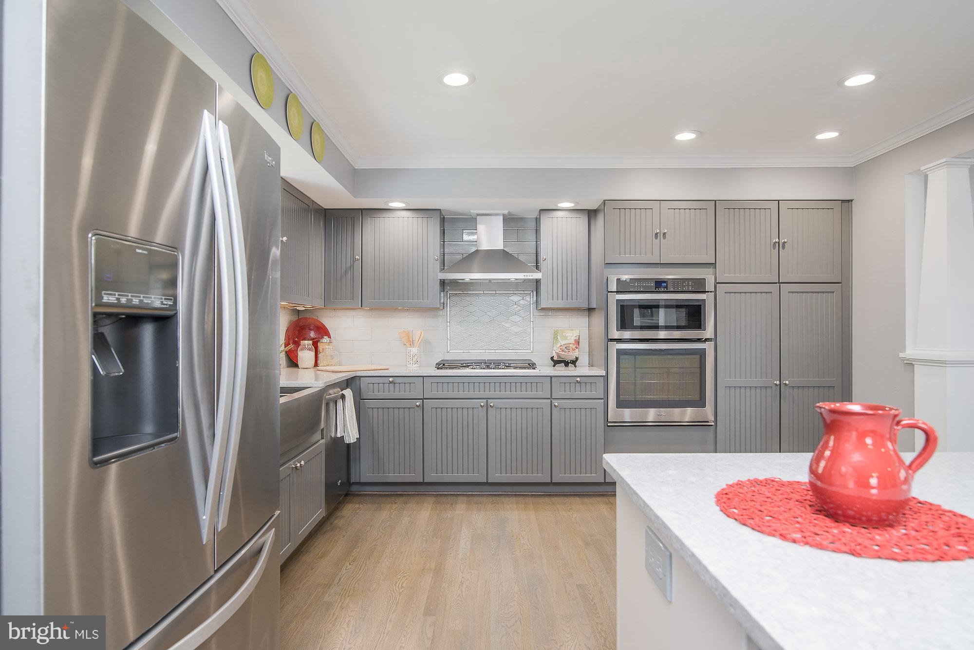 8821 Weems Road Manassas, VA 20110 - Photo 13 of 30 a kitchen with stainless steel appliances granite countertop a refrigerator and a sink