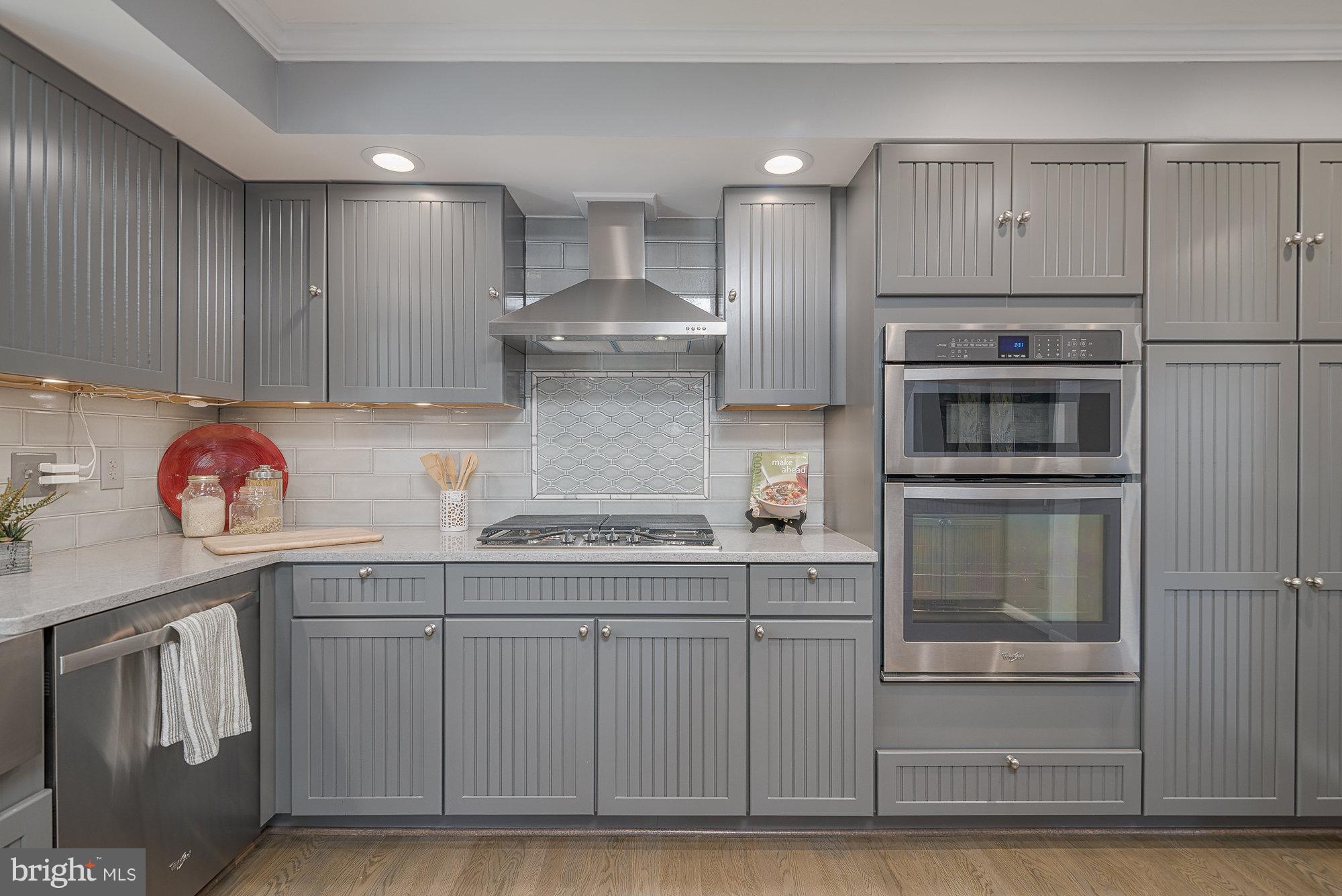 8821 Weems Road Manassas, VA 20110 - Photo 14 of 30 a kitchen with kitchen island granite countertop cabinets and stainless steel appliances