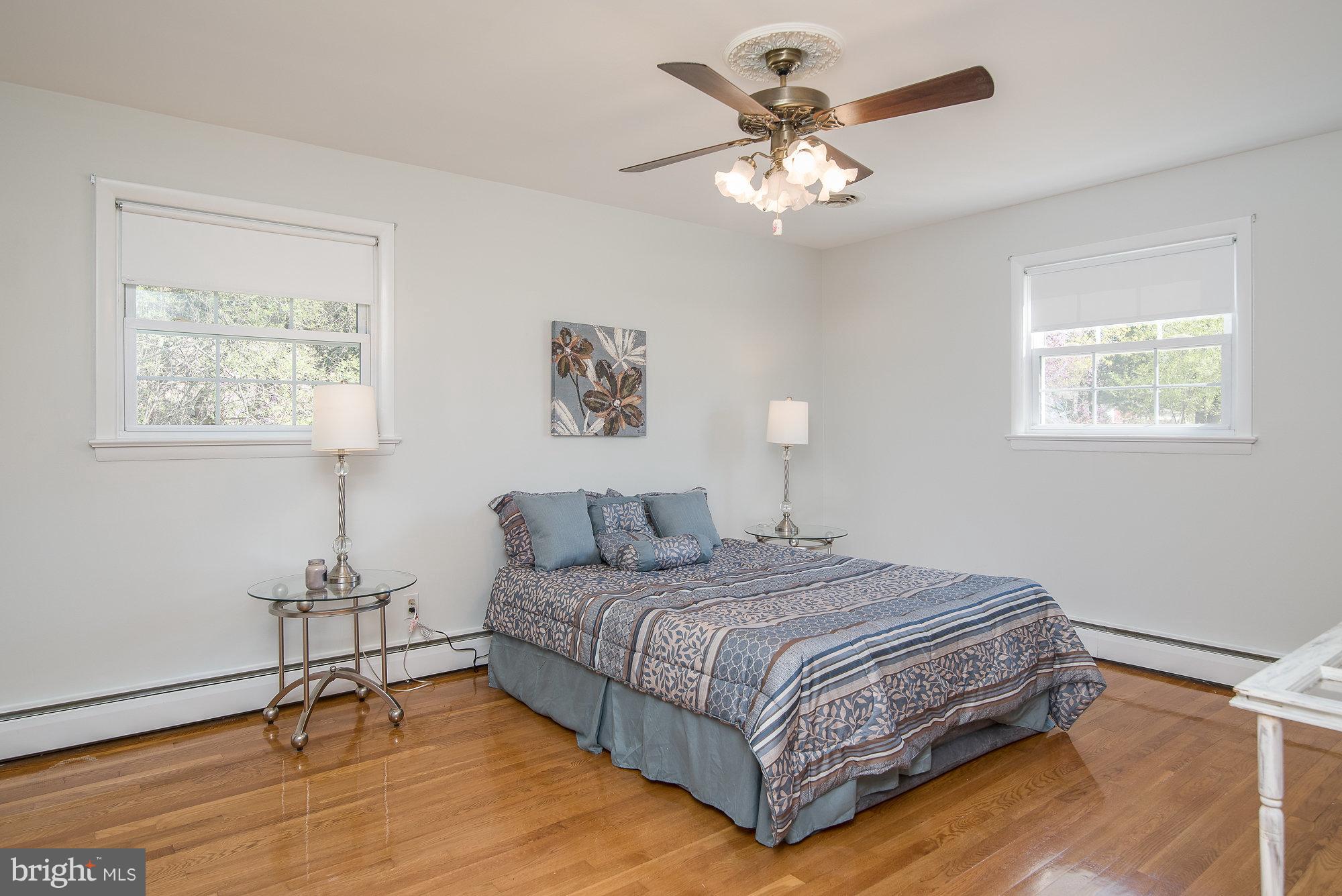 8821 Weems Road Manassas, VA 20110 - Photo 17 of 30 a bedroom with a bed chandelier and a window