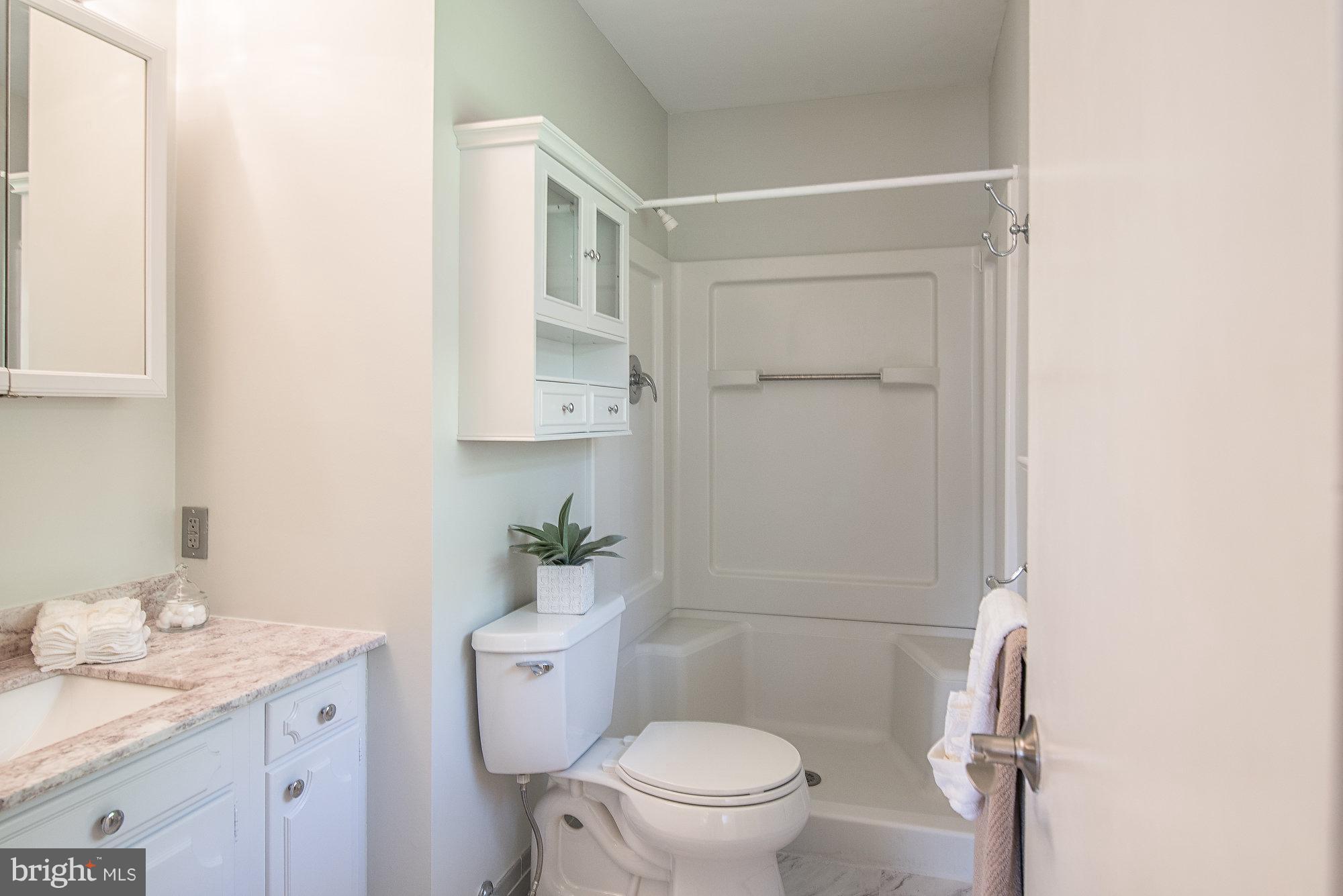8821 Weems Road Manassas, VA 20110 - Photo 21 of 30 a bathroom with a granite countertop toilet sink and mirror
