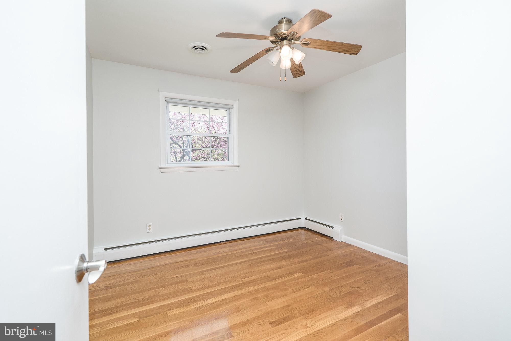 8821 Weems Road Manassas, VA 20110 - Photo 25 of 30 an empty room with a window and a ceiling fan
