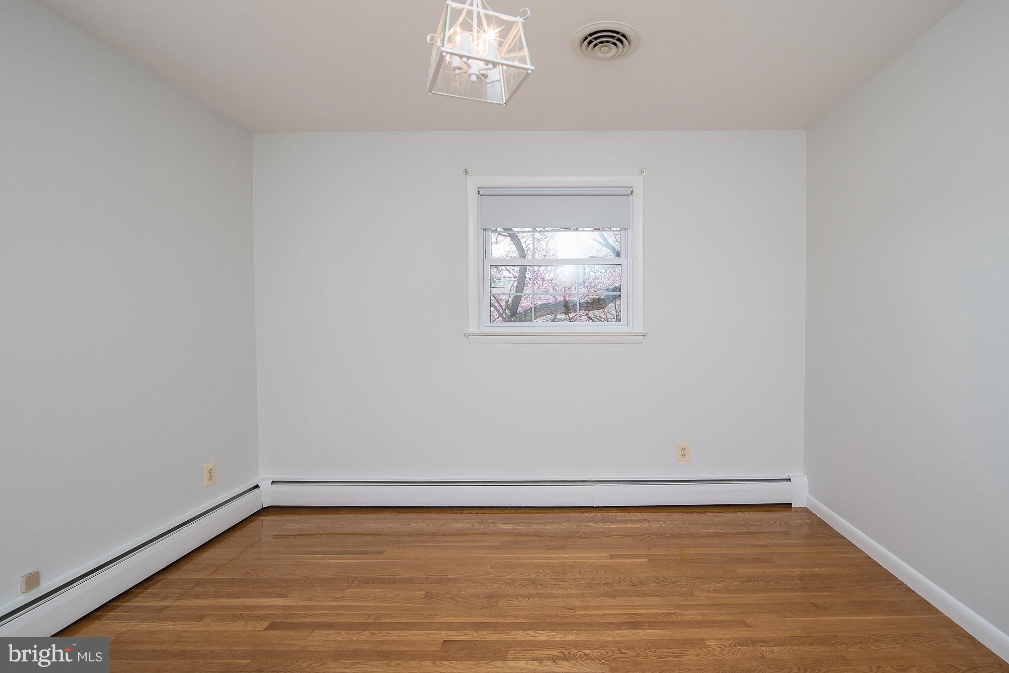 8821 Weems Road Manassas, VA 20110 - Photo 26 of 30 a view of an empty room with wooden floor and a window