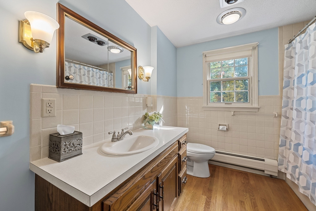 55 Warren Street Boylston, MA 01505 - Photo 11 of 30 a bathroom with a sink vanity mirror and toilet