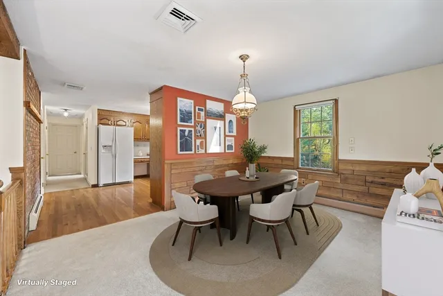 a view of a dining room with furniture and window