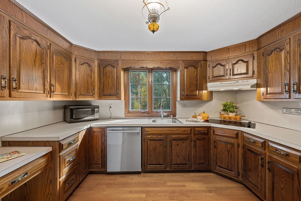 55 Warren Street Boylston, MA 01505 - Photo 8 of 30 a kitchen with a sink stove and cabinets