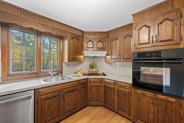 a kitchen with stainless steel appliances granite countertop a sink stove and cabinets