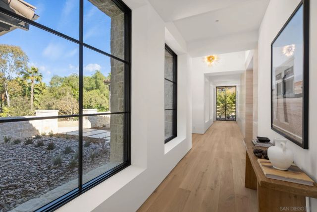 a bedroom with a bed mirror and window