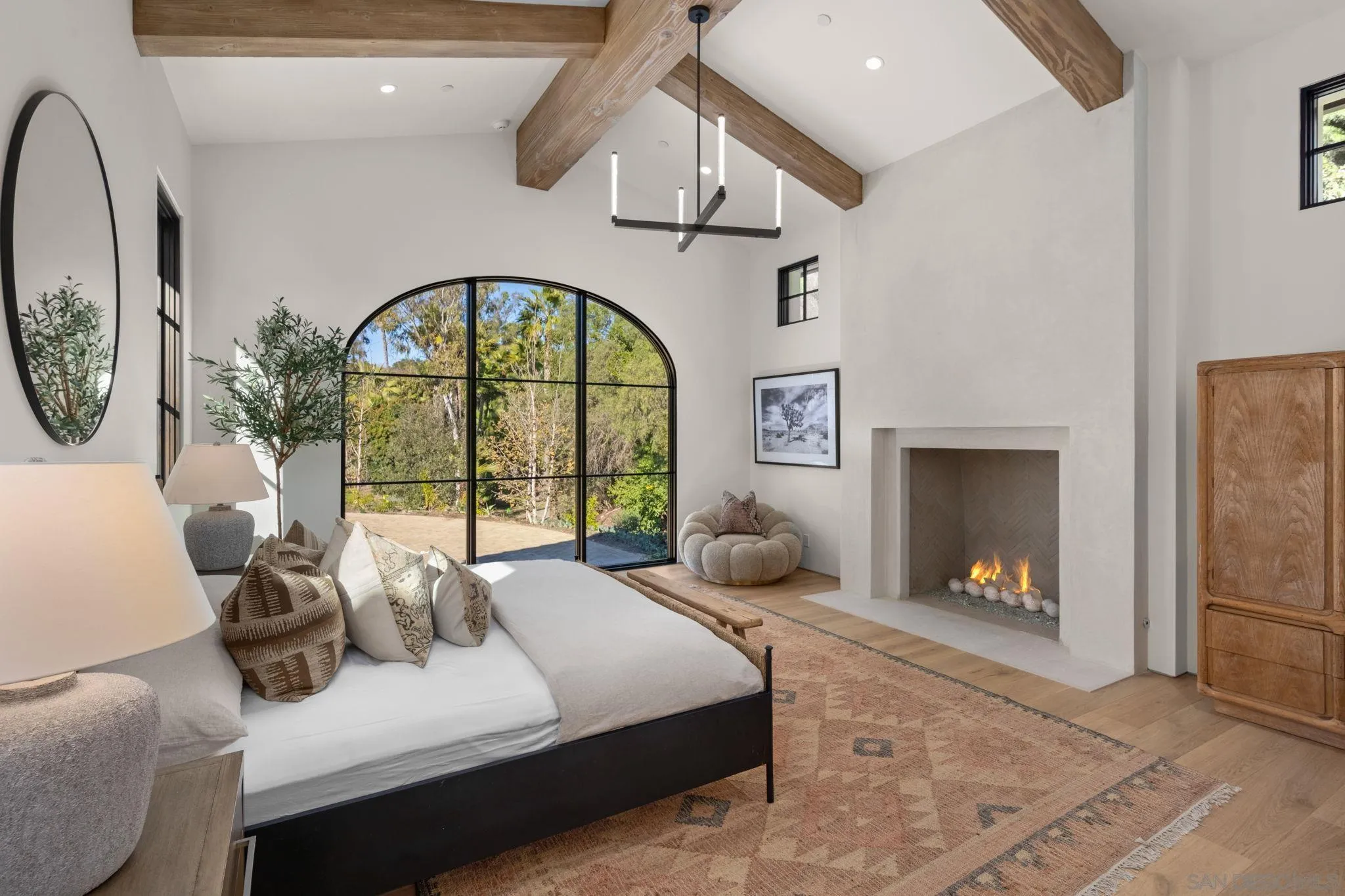 6323 Mimulus Rancho Santa Fe, CA 92067 - Photo 21 of 32 a bedroom with a bed a mirror and a fireplace