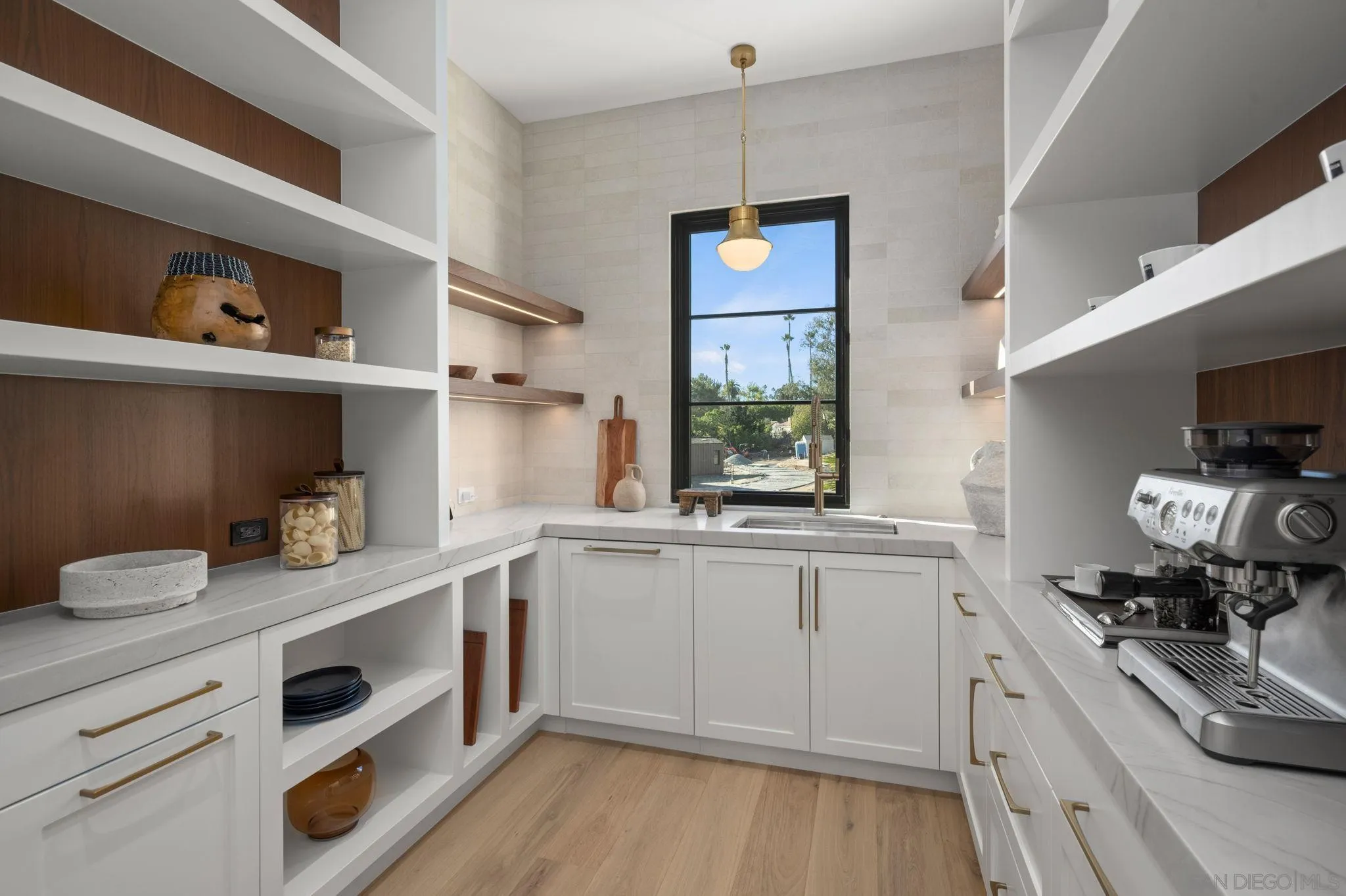 6323 Mimulus Rancho Santa Fe, CA 92067 - Photo 7 of 32 a kitchen with granite countertop white cabinets and wooden floor