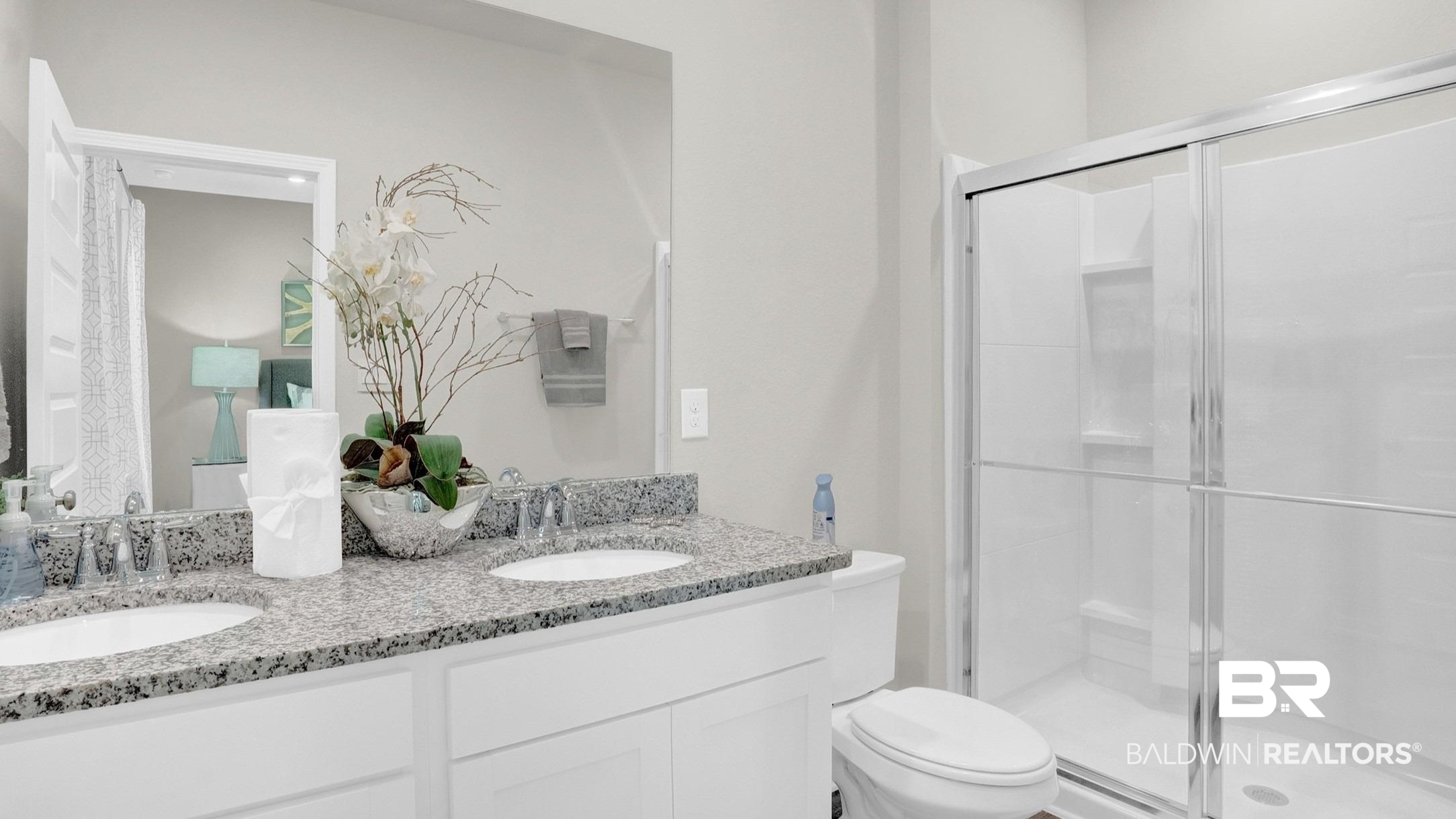 13330 Shea Circle Foley, AL 36535 - Photo 14 of 15 Bathroom featuring a double vanity with granite countertops, undermount sinks, and white cabinetry