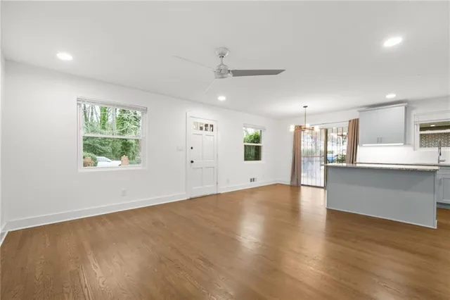 an empty room with a empty space and a ceiling fan