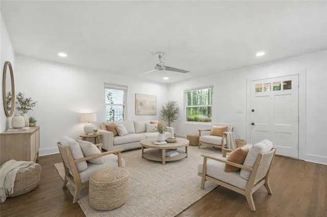 a living room with furniture and wooden floor