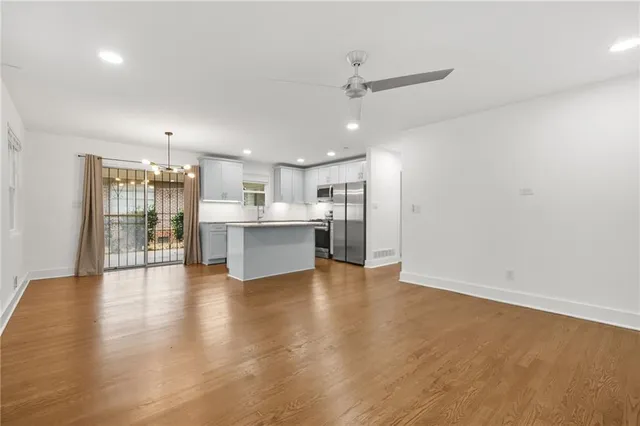 a bedroom with a bed painting on wall and wooden floor