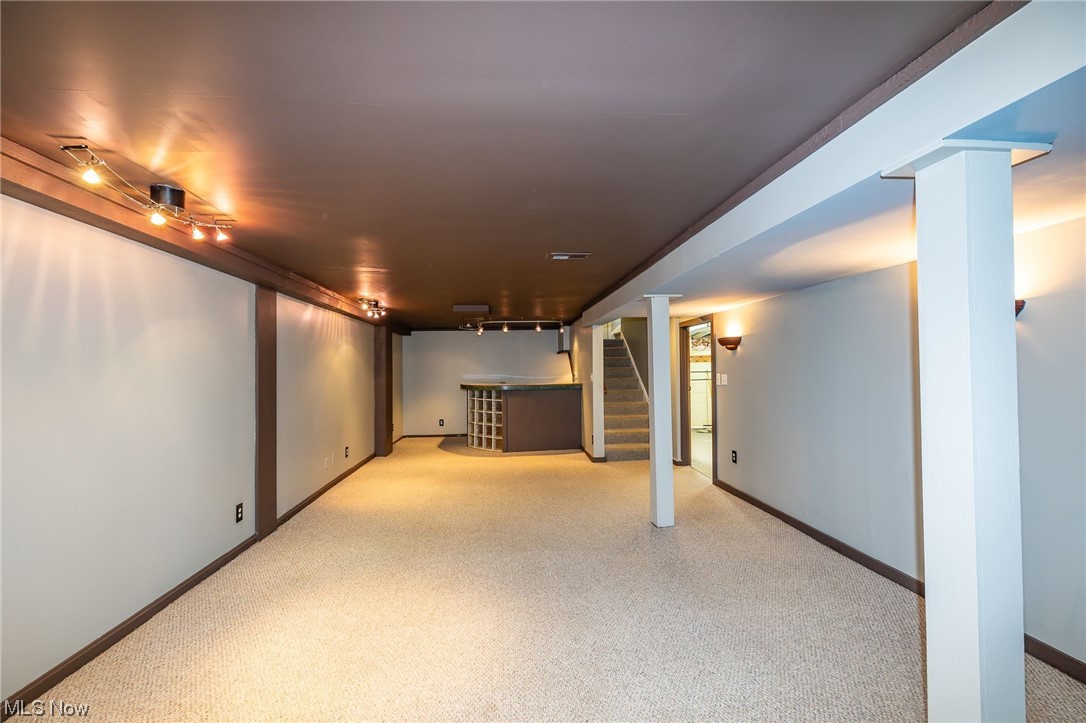 4979 South Barton Road Cleveland, OH 44124 - Photo 21 of 25 Basement featuring bar area and light carpet