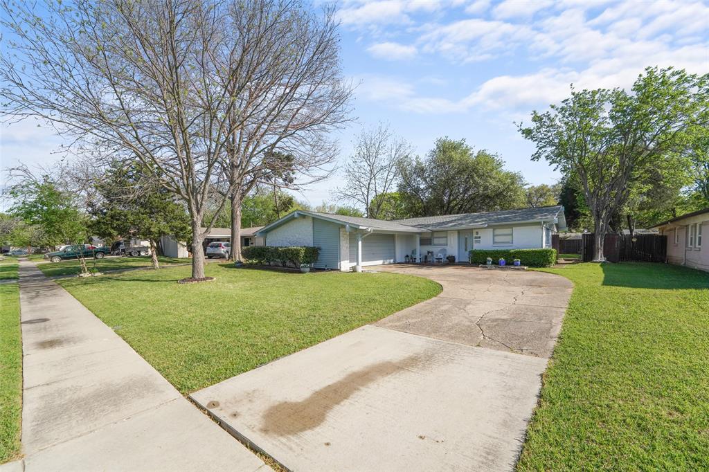 3218 Modella Avenue Dallas, TX 75229 - Photo 1 of 1 a front view of a house with garden