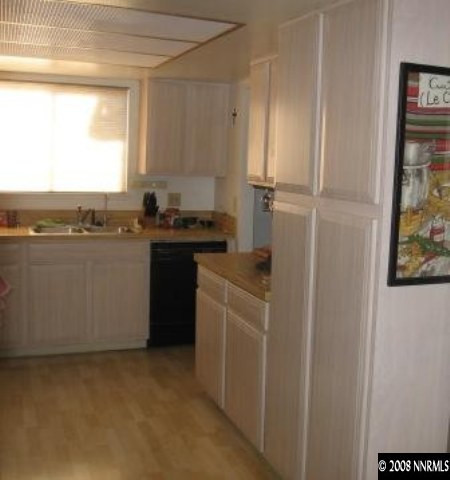 1141 Rayburn Drive Reno, NV 89503 - Photo 7 of 9 a kitchen with cabinets and a refrigerator