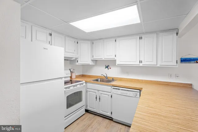 a kitchen with a white cabinets and white appliances