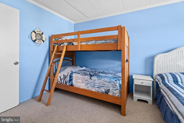 a bedroom with a bunk bed and a dresser