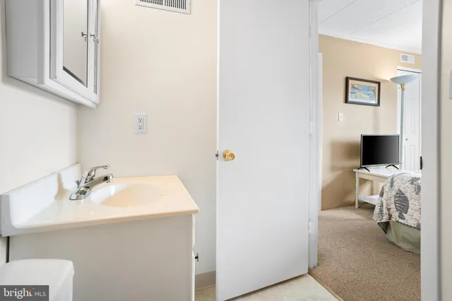 a en suite bathroom with a sink and a mirror