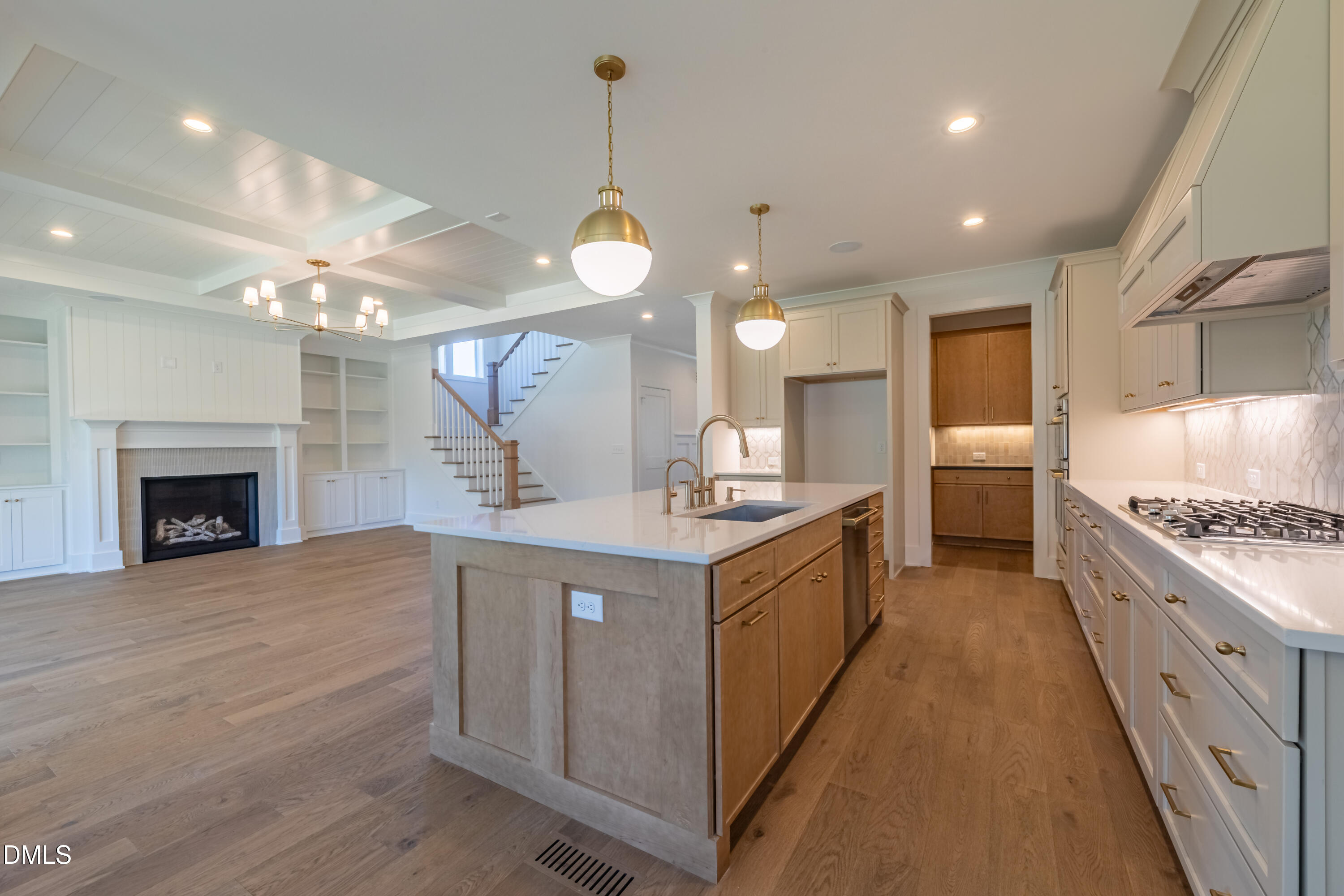 5709 Flowery Mdw Court Wake Forest, NC 27587 - Photo 19 of 69 a large kitchen with a large island in the center a sink stainless steel appliances and cabinets