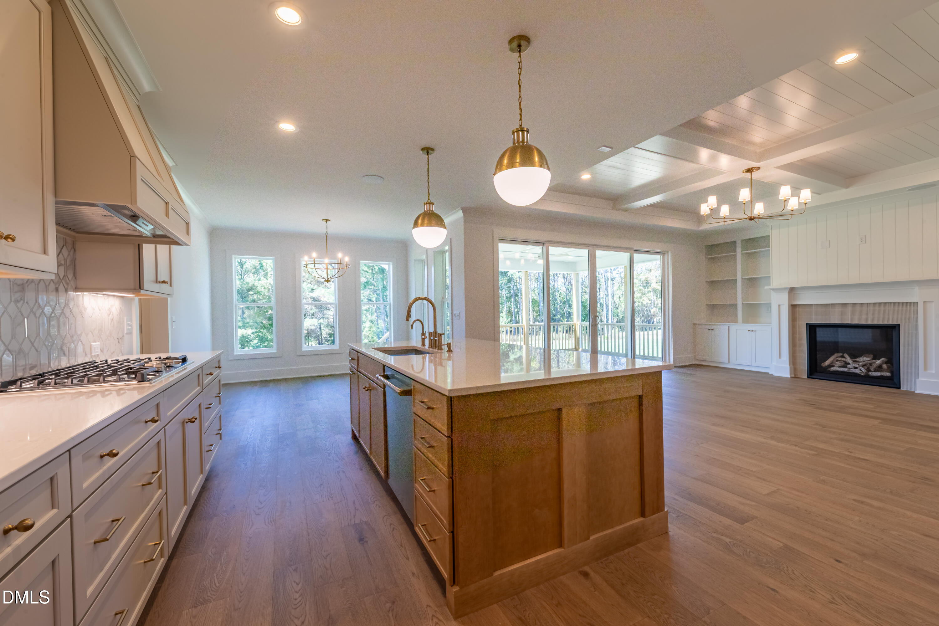 5709 Flowery Mdw Court Wake Forest, NC 27587 - Photo 20 of 69 a kitchen with stove a sink dishwasher and a fireplace with wooden floor