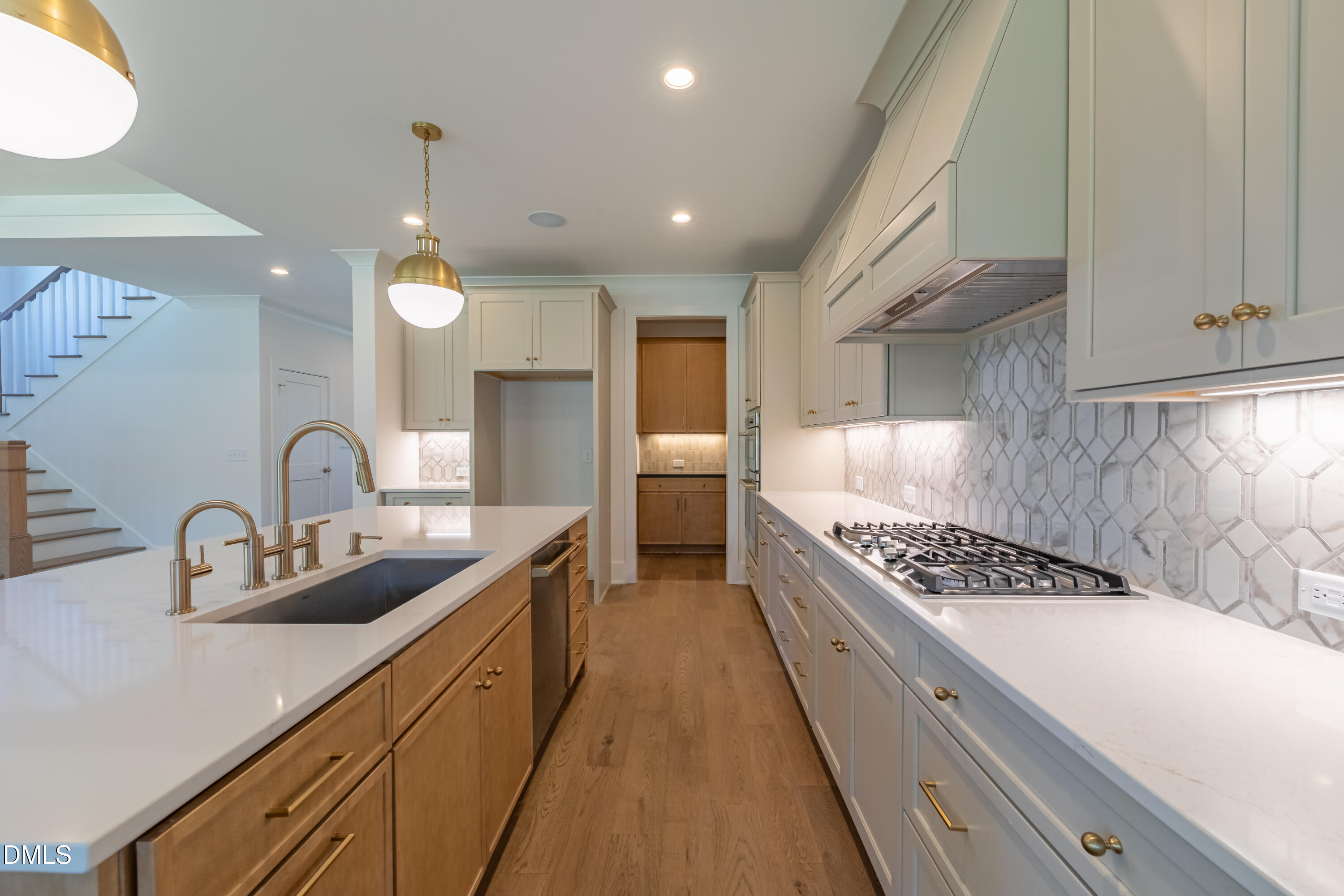 5709 Flowery Mdw Court Wake Forest, NC 27587 - Photo 22 of 69 a kitchen with kitchen island stainless steel appliances a sink stove and cabinets