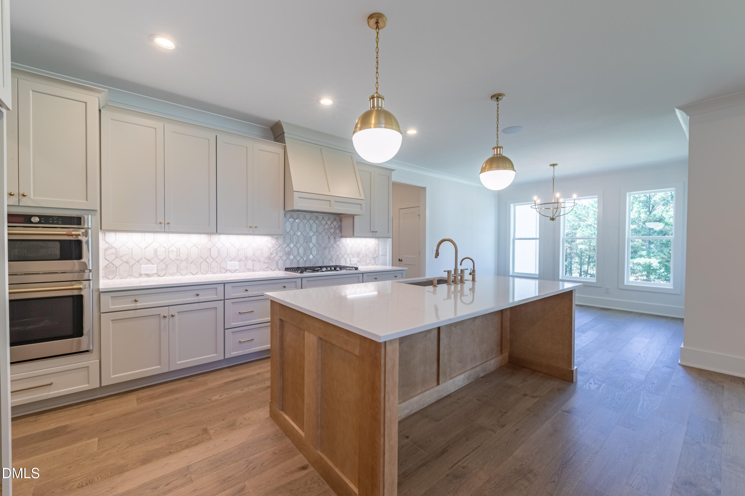 5709 Flowery Mdw Court Wake Forest, NC 27587 - Photo 24 of 69 a kitchen with a sink cabinets stainless steel appliances and a large window