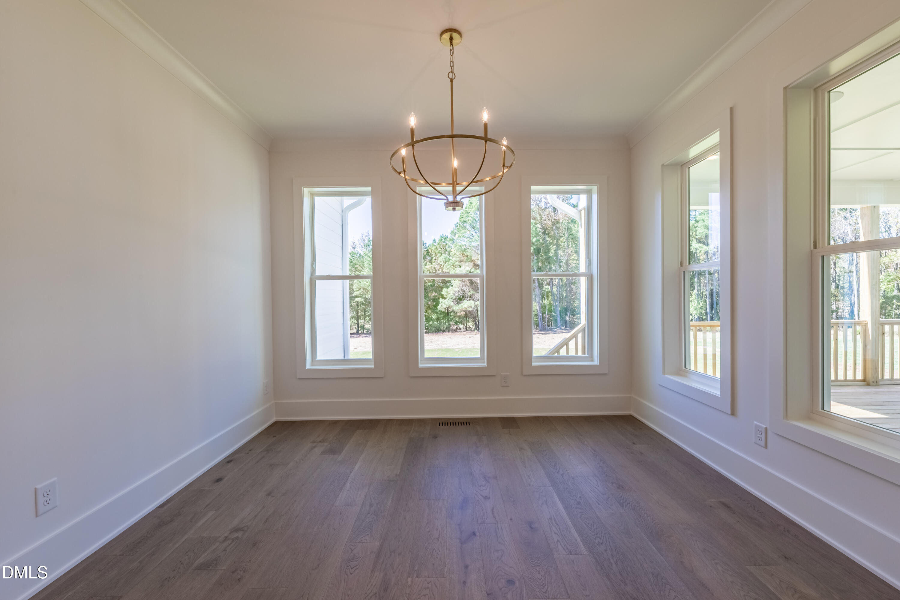 5709 Flowery Mdw Court Wake Forest, NC 27587 - Photo 28 of 69 an empty room with wooden floor and windows