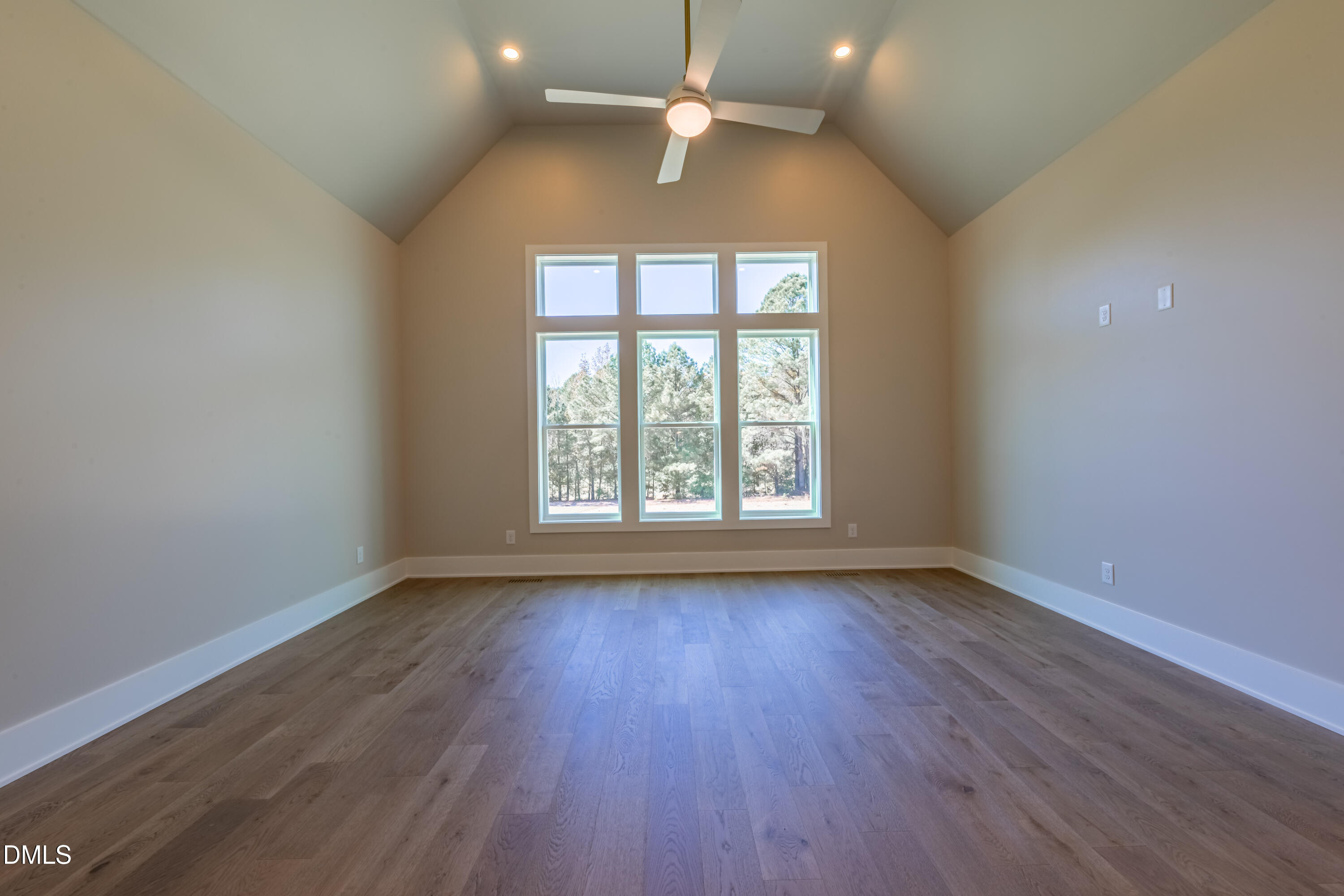 5709 Flowery Mdw Court Wake Forest, NC 27587 - Photo 39 of 69 an empty room with wooden floor chandelier fan and windows