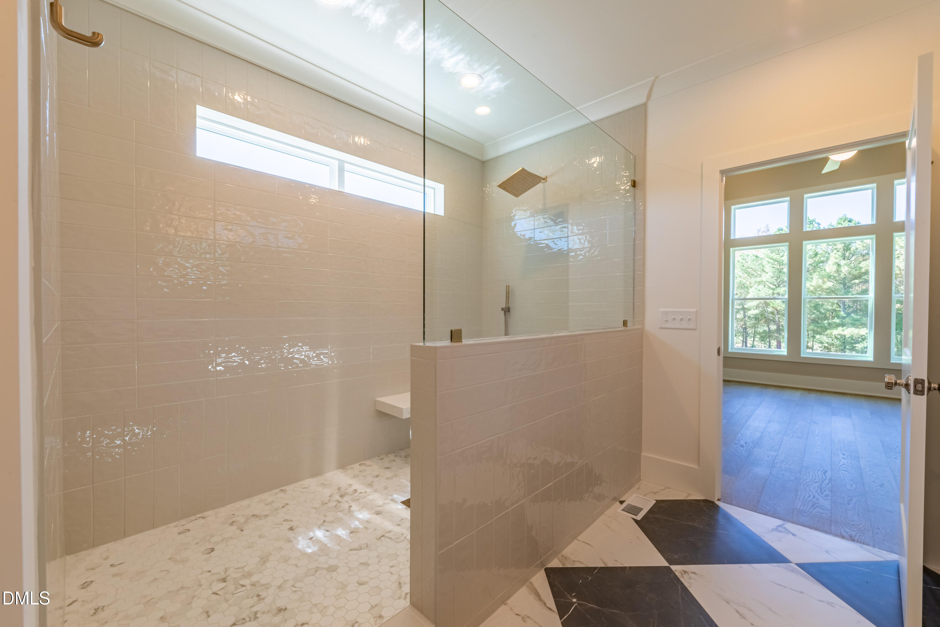5709 Flowery Mdw Court Wake Forest, NC 27587 - Photo 44 of 69 a bathroom with a glass shower door and a window