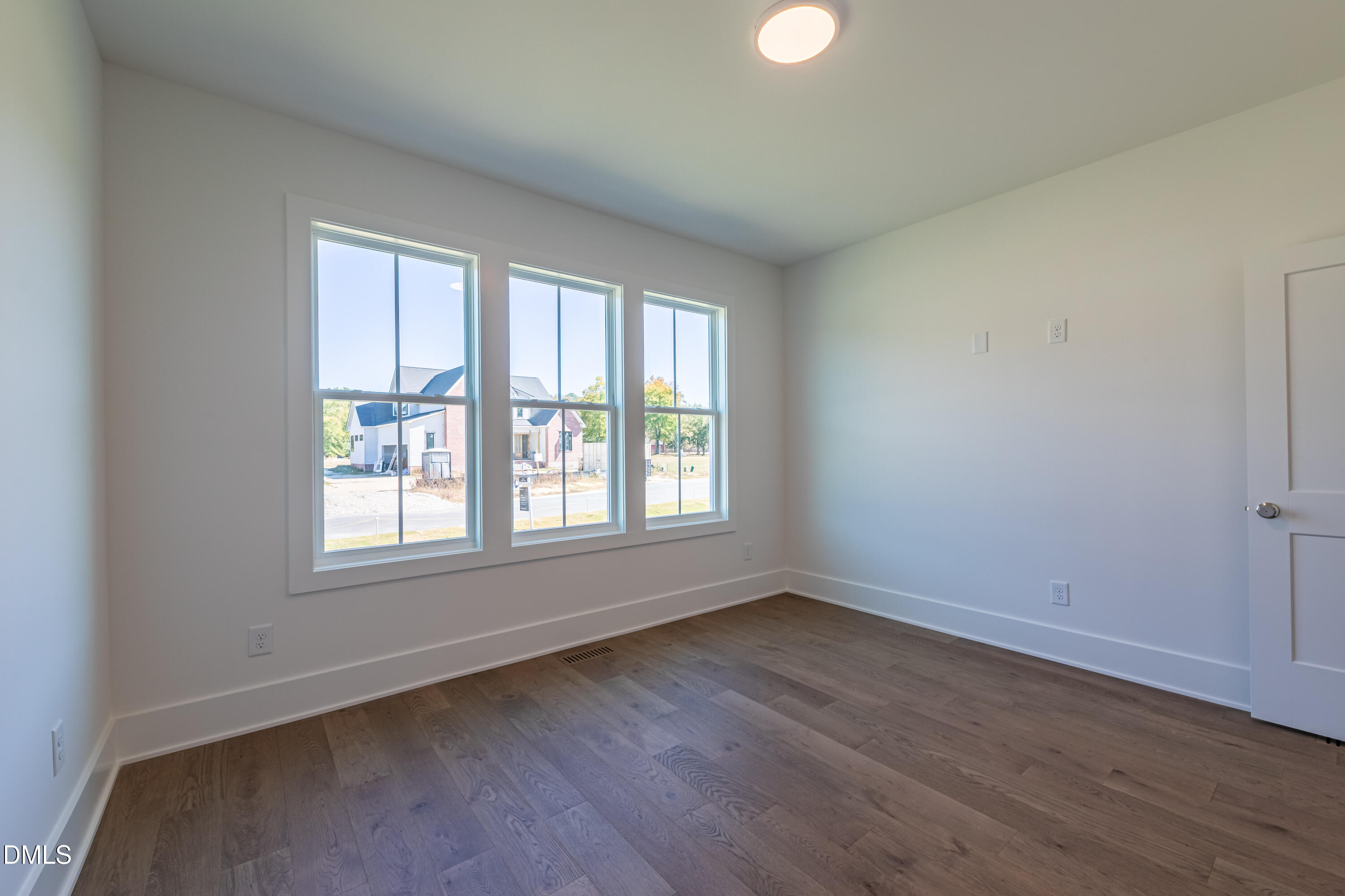 5709 Flowery Mdw Court Wake Forest, NC 27587 - Photo 47 of 69 an empty room with wooden floor and windows