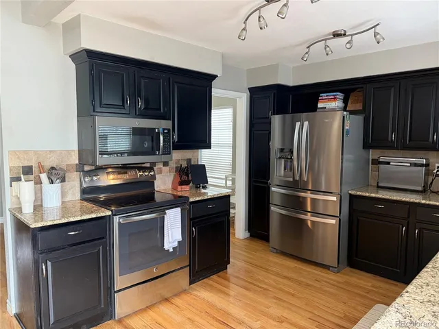 a kitchen with a refrigerator stove and microwave