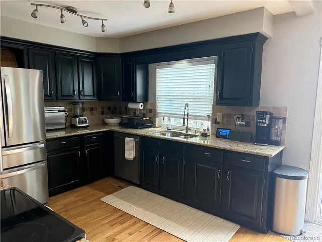 a kitchen with a sink stove and refrigerator