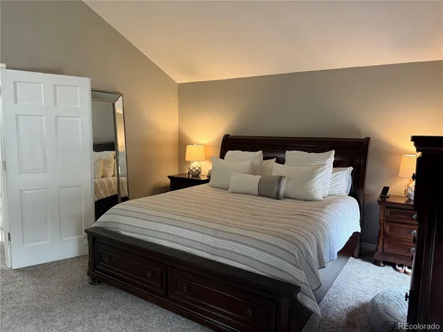 a bedroom with a bed and a night stand