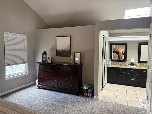a spacious bathroom with a tub sink and mirror