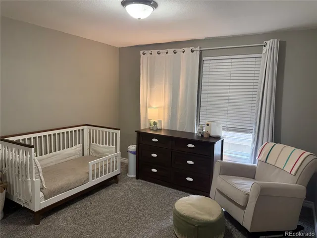 a bedroom with a bed and a couch