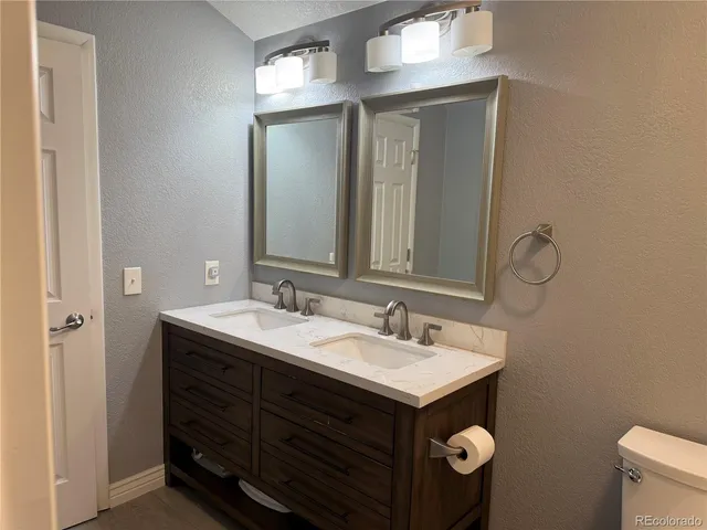 a bathroom with a sink vanity and mirror