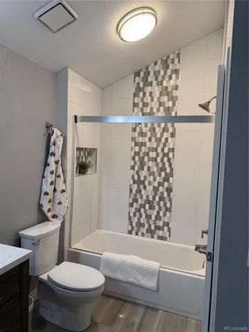 a bathroom with a toilet and shower