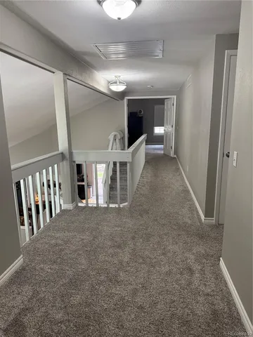 a view of a hallway with stairs